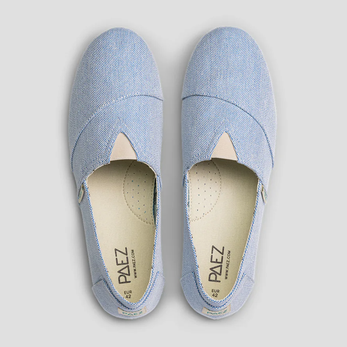 Top view of light blue PAEZ slip-on shoes showcasing the textured fabric and inner sole details.