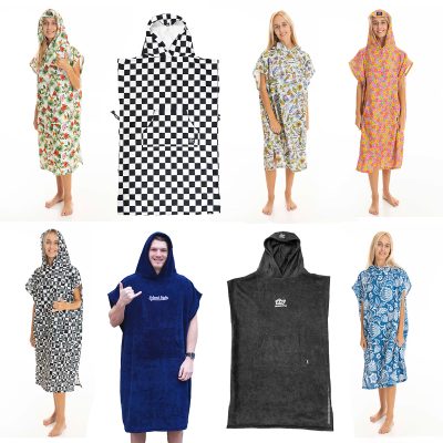 A collection of hooded poncho changing towels in various prints and solid colors, displayed on models and as standalone flat-lay images.