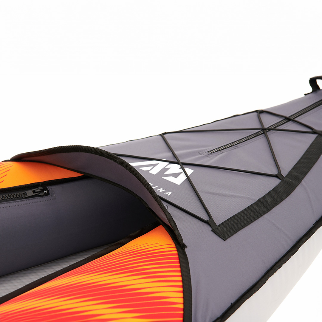 Close-up of the Aqua Marina MEMBA inflatable kayak's deck shield with bungee cords.