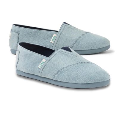 Pair of PAEZ espadrille slip-on shoes for women in denim blue, displayed from two angles with matching blue soles.